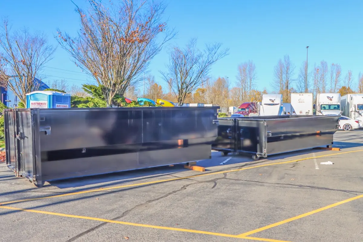 Professional dumpster rental service with roll-off container on residential driveway in Friendswood